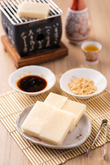 Fresh Tofu with Sauce and Condiments on a Table