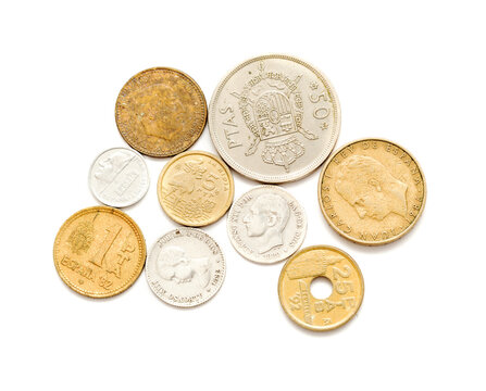 Out of circulation Spanish pesetas, coins and one banknote of one hundred, isolated on white background