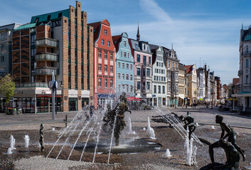 View of the old town of the Hanseatic city of Rostock with fountains and old rows of houses,...