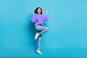 Full length body size view of attractive cheerful lucky girl jumping dancing rejoicing isolated over bright blue color background