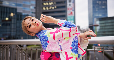 Asian woman, portrait and dancing with kimono in city for performance, tradition or Kpop culture in...
