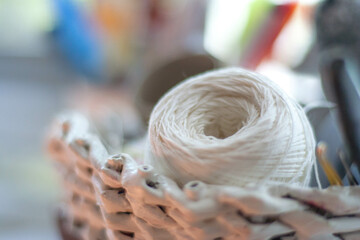 A basket with threads for knitting and needlework in the close-up shot