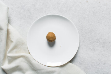 Top view of donkwa on a white plate, Overhead view of nigerian spicy donkwa, flatlay of tanfiri or groundnut cake on a white ceramic plate