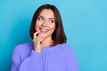 Fototapeta premium Portrait of attractive cheerful bewildered curious girl touching lip guessing copy space isolated over vivid blue color background