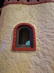 An old window on the wall from ancient heritage