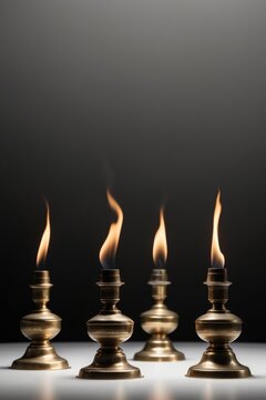Brass oil lamps glowing in a dark setting.