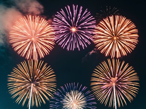 Colorful fireworks exploding in night sky celebrating new year's eve.