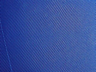 Close-up of denim fabric texture with visible stitching, weave
