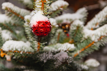A Christmas tree decorated with festive decorations and sprinkled with soft snow