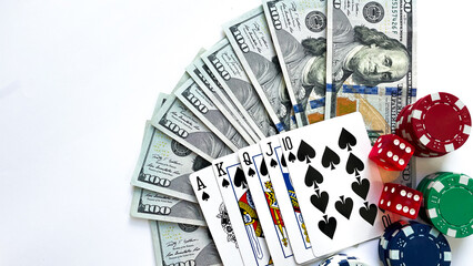 Fototapeta na wymiar A poker setup featuring a royal flush in spades, stacks of red, green, blue poker chips, red dice, and a fan of US dollar bills, ideal for casino promotions, gambling advertisements, or game night vis