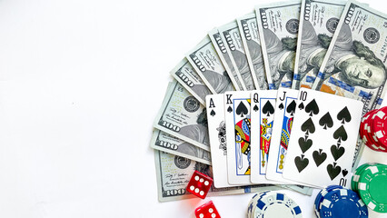 Fototapeta na wymiar A poker setup featuring a royal flush in spades, stacks of red, green, blue poker chips, red dice, and a fan of US dollar bills, ideal for casino promotions, gambling advertisements, or game night vis