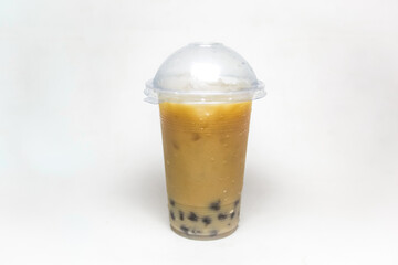 Cold tapioca pearl bubble drink in plastic cup isolated on white background