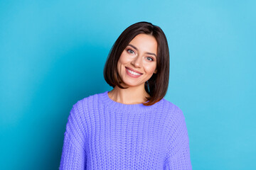 Fototapeta premium Portrait of attractive cheerful funny brunette girl wearing warm jumper wintertime isolated over bright blue color background