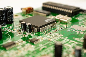 Close-up of a circuit board with microcircuits from an electrical appliance or computer. Selective focus.