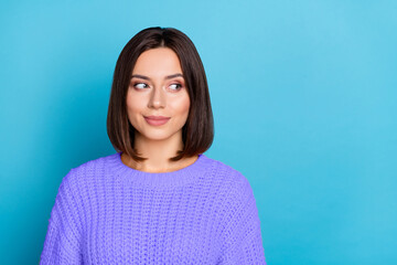 Fototapeta premium Portrait of attractive girlish suspicious girl looking aside making decision isolated over bright blue color background