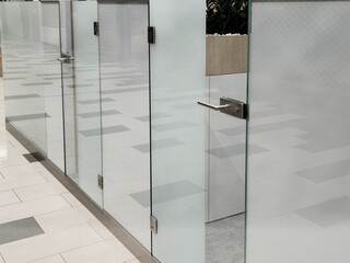frameless glass door. glazed partitions have special hinges and handles. everything is drilled into the glass and attached with stainless steel screws. polished bar handle