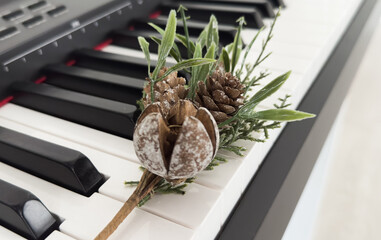 Christmas musical performance background with piano and trombone with christmas decoration, slider and mouthpiece. Top view.