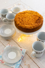 Homemade pie with cherry confit and sour cream souffle on laid table for tea party