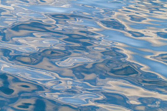 Reflections of the sky mirrored in the calm waters of Stanley in the Falkland Islands, South Atlantic Ocean