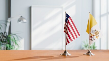 FLAGS OF LIBERIA AND VATICAN ON TABLE