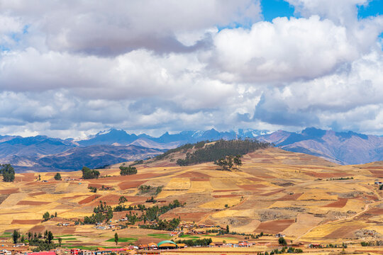 Fields around Racchi village near Chinchero with distant views of Andes mountains, Sacred Valley, Peru