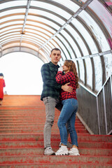 Romantic couple embracing on a stairway under an arching structure