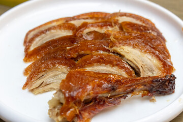 Chinese cook prepares Peking Roast Duck.