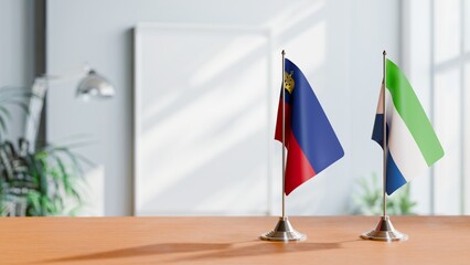 FLAGS OF LIECHTENSTEIN AND SIERRA LEONE ON TABLE