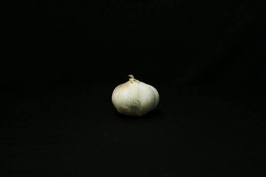 garlic and onion on black background