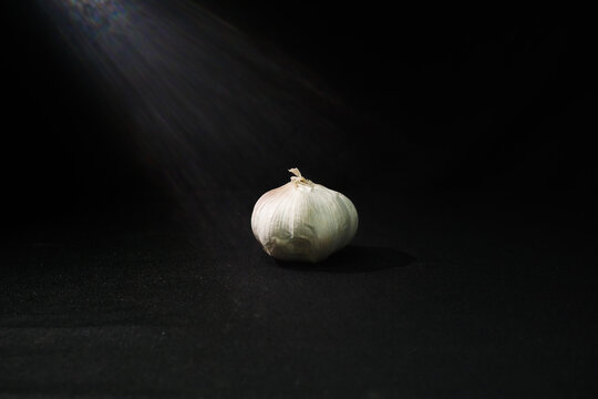 garlic and onion on black background