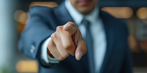 business man pointing finger to front camera bokeh light building blur background