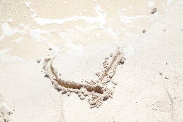 Heart drawn on the beach sand