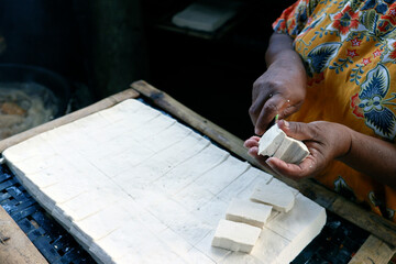 Worker making tofu, a food prepared by coagulating soy milk, in a traditional family factory, Yogyakarta, Java, Indonesia, Southeast Asia