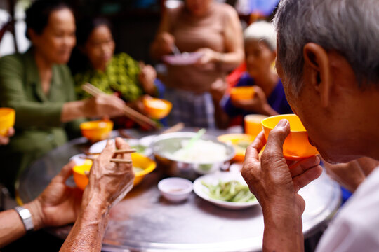 A group of friends enjoy a meal at a vegetarian restaurant, An Giang Province, Mekong Delta, Vietnam, Indochina, Southeast Asia
