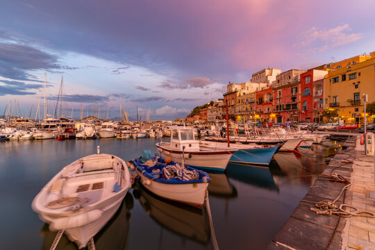 View of the fishing port Marina Grande with boats at golden hour, Procida, Phlegraean Islands, Gulf of Naples, Campania, Southern Italy, Italy