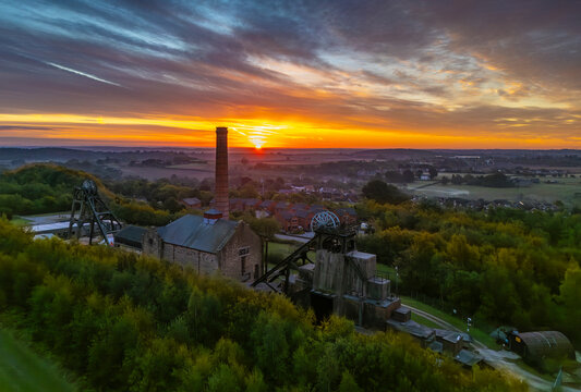 Aerial view of pit headstocks at Pleasley Country Park during sunset, Pleasley, Bolsover, Derbyshire, England, United Kingdom
