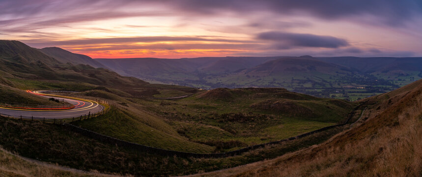 View of landscape and trail lights in the Hope Valley at sunset, Peak District National Park, Baslow, Derbyshire, England, United Kingdom