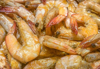 Closeup of orange cooked shrimps background from top angle