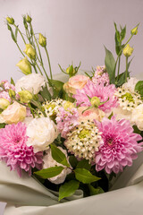 Bouquet of flowers with pink roses, chrysanthemum and freesia flower in a vase isolated on a white background.