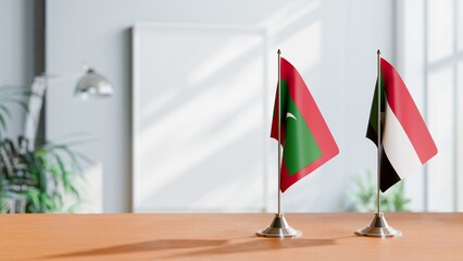 FLAGS OF MALDIVES AND SUDAN ON TABLE