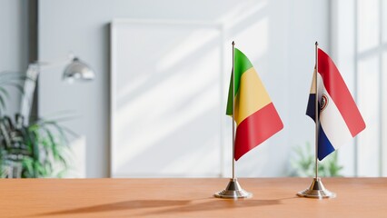 FLAGS OF MALI AND PARAGUAY ON TABLE