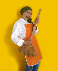 Attractive Young Woman Using Broom Like Playing Guitar Having Fun While Cleaning House