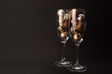 New Year composition with two glasses, decoration and lights.