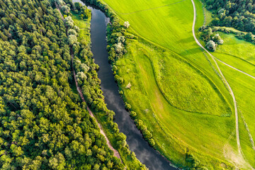 Earth landscape from the air, view of forest and field separated by river