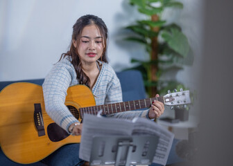 Woman Practicing Acoustic Guitar at Home