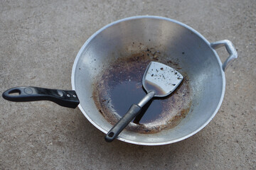 Metal pan after cooking with dirty used oil and ladle in it. Concept, unhealthy cooking. Oil used...