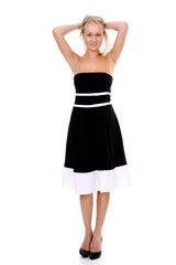Portrait of a young beautiful blonde girl in a black dress