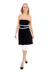 Fototapeta premium Portrait of a young beautiful blonde girl in a black dress