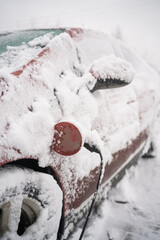 Red Electric Car Charging in the Snow