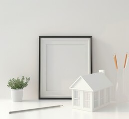 White minimalist home office desk with a black frame. small house model. pencil and potted plant